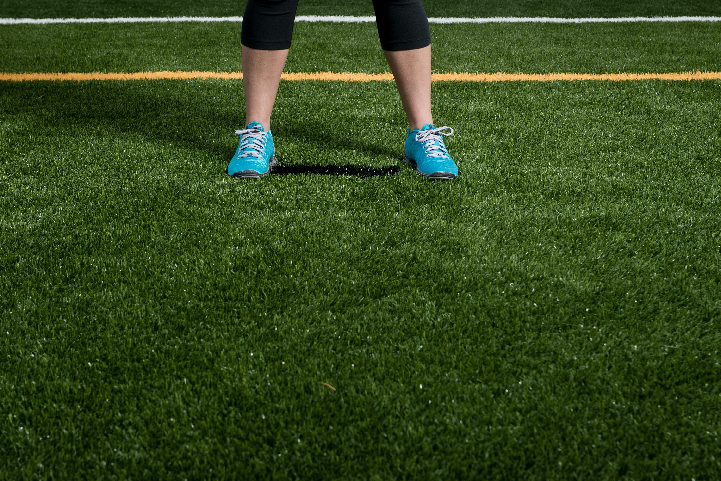 person standing on green grass field